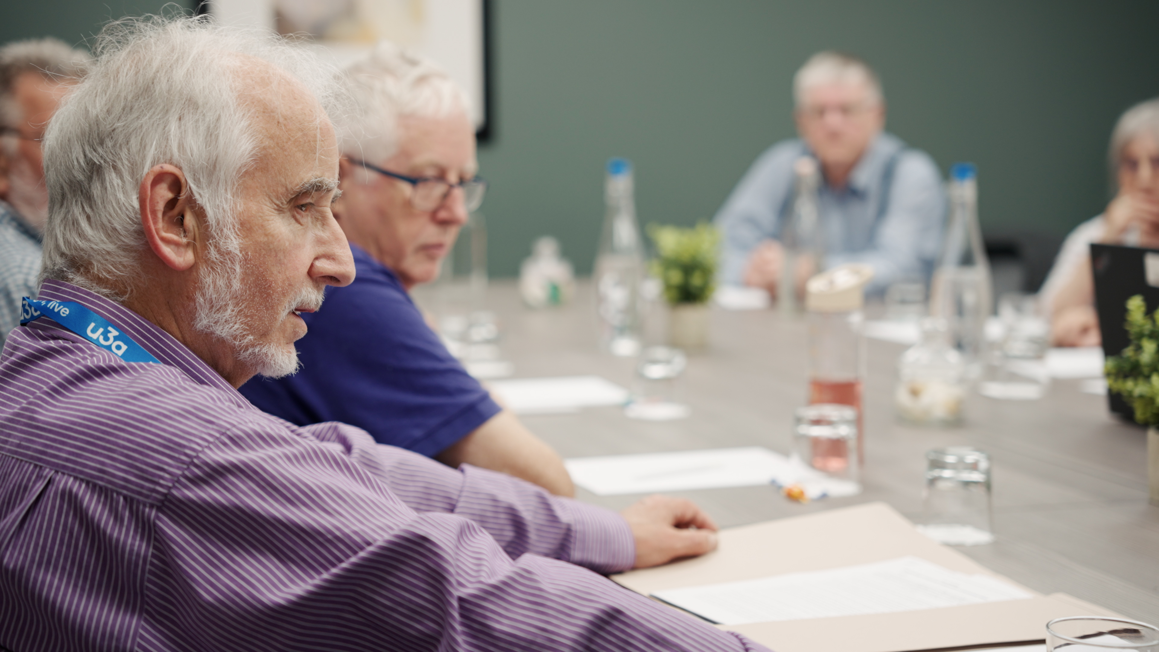 Close up of a man sitting at a table