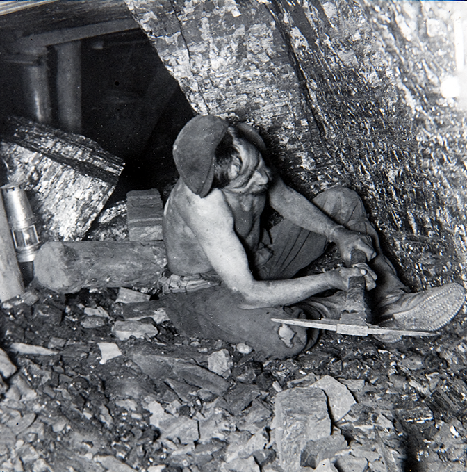 Miner using pick at Coalface, 1913. Image courtesy of the National Archives.